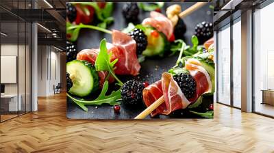 Party appetizers consisting of skewered prosciutto blackberries cucumber and arugula creating a colorful and tasty combination on a copy space image Wall mural