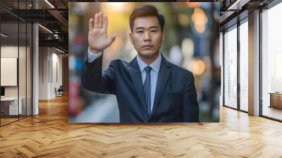 photo of an asian man in a suit holding his hand up signalling stop, hyper realistic, bright background Wall mural