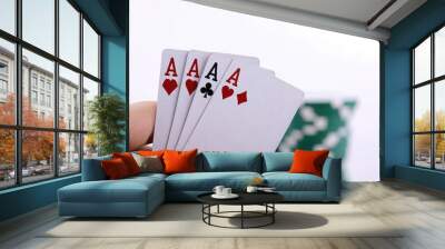 Poker cards in hand, close-up of the card with three Aces on it and a white background Wall mural