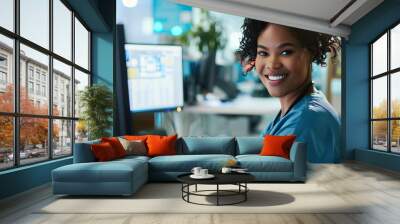 Portrait, nurse and receptionist at hospital on a computer working at her desk or table in an office as a black woman. Medical, healthcare professional or worker smile, happy and excited at work Wall mural