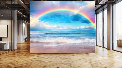 Rainbow in sky over ocean with beach in foreground and waves in the foreground Wall mural