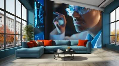 Scientist in glasses looking at screen with medical brain data Wall mural