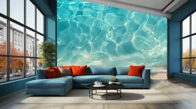 sea water waves texture ripples on water surface light blue ocean water top view clear aqua background sun glow reflection white sand bottom stones underwater tropical island beach Wall mural