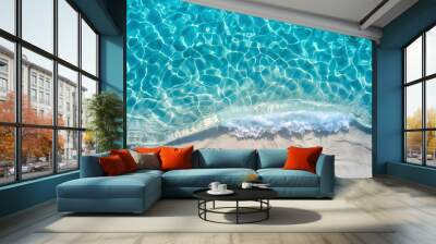 sea water waves texture ripples on water surface light blue ocean water top view clear aqua background sun glow reflection white sand bottom stones underwater tropical island beach Wall mural