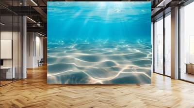 seabed sand with blue tropical ocean above empty underwater background with the summer sun shining brightly creating ripples in the calm sea water. Wall mural