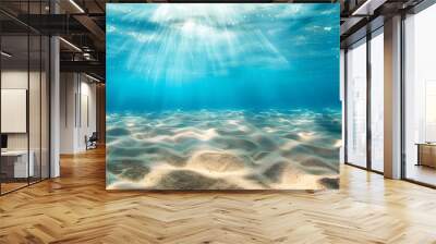 seabed sand with blue tropical ocean above empty underwater background with the summer sun shining brightly creating ripples in the calm sea water. Wall mural