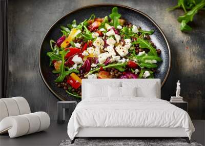 Studio shot of plate of vegetarian salad with lentils, arugula, feta cheese, radicchio and bell pepper Wall mural