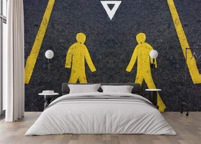 surreal abstract icon of pedestrian male crossing the road in YELLOW paint on black asphalt background repeating patterns Wall mural