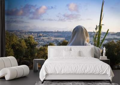 Succot (Feast of Tabernacles) in Jerusalem: Jewish man in a Tallit praying while waving the Four Species, with a view towards the Temple Mount, the Old City and the Mount of Olives Wall mural