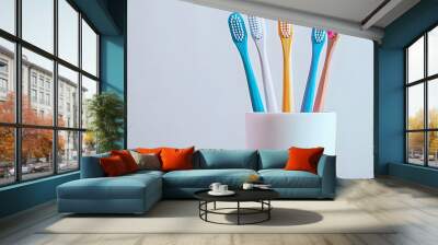 Toothbrushes in a container with a white background displaying copy space image Wall mural