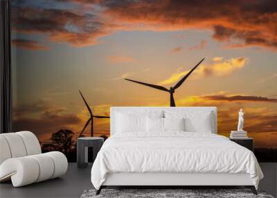 Two wind turbines at sunset, generating electricity for the national grid. Wall mural