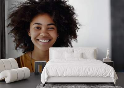 Waist-up shot of cute carefree friendly-looking African American teenage girl with afro hairstyle smiling broadly with shy and happy expression meeting new classmates over gray background Wall mural