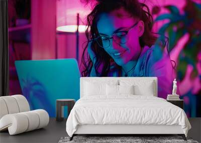 Woman working on laptop in pink neon light Wall mural