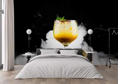 yellow fruit cocktail in a glass cup on a wooden log, with some catrina-type skulls, with some slices of lulo, a dark background and a layer of dry ice smoke
 Wall mural