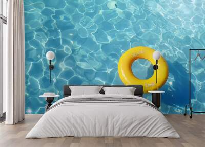 yellow swimming pool ring float in blue water. concept color summer. Wall mural