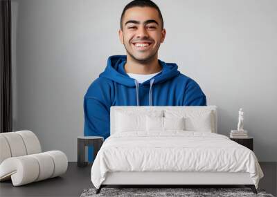 Young smiling happy cheerful middle eastern man he wears blue hoody casual clothes hold satisfied hands crossed folded look camera isolated on plain solid white background studio. Lifestyle concept. Wall mural