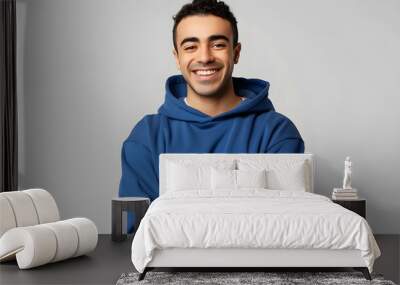 Young smiling happy cheerful middle eastern man he wears blue hoody casual clothes hold satisfied hands crossed folded look camera isolated on plain solid white background studio. Lifestyle concept. Wall mural