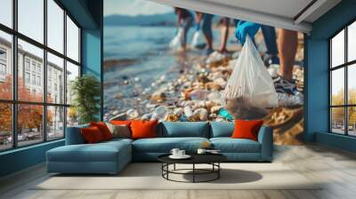 Activist people collect plastic trash on the beach. Men and women clean the beach with bags. Concept of environmental protection and ocean pollution problems Wall mural