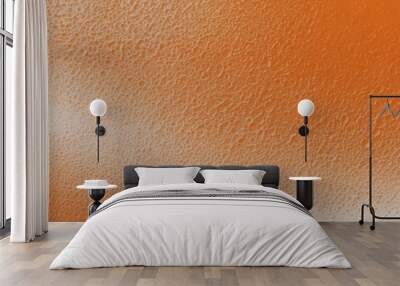 Close-up of textured orange surface with light gradient Wall mural