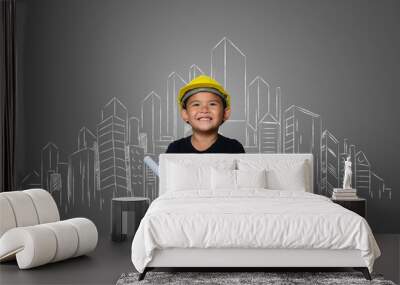 A boy wearing a yellow engineer hat and a house plan on a blackboard Wall mural