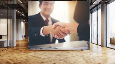 Business people shaking hands while sitting at the working place, Finish success business good deals meeting Wall mural