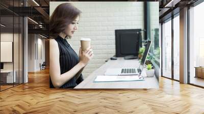 Business woman have a break with coffee in hand while working at office. Wall mural