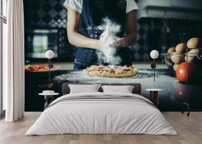 Hands in flour on black background. Making pizza in kitchen. Wall mural