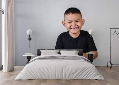 Happy boy play game computer with a controller in studio photo Wall mural