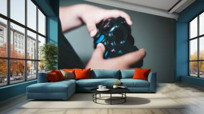 Happy boy play game computer with a controller in studio photo Wall mural