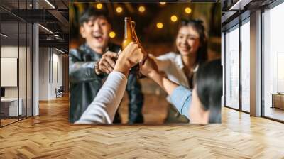 Portrait of Happy Asian friends having dinner party together - Young people sitting at bar table toasting beer glasses dinner outdoor  - People, food, drink lifestyle, new year celebration concept. Wall mural