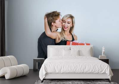 Portrait of happy young couple love together surprise with gift box in studio Wall mural