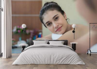 Two cute young women during a skin care treatment at a spa. Wall mural