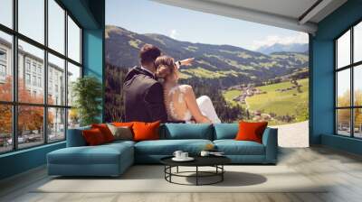 Just married man and woman enjoing in view on mountain in suny d Wall mural