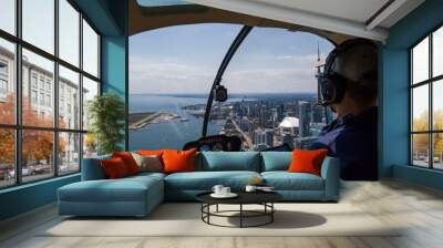  Inside view of a helicopter in flight, with man pilot. Downtown city landscape of Toronto on a sunny day. Wall mural