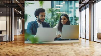 Two Colleagues Working on Laptops in a Modern Office Wall mural