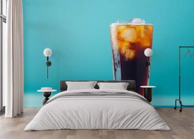 A refreshing cold brew in a tall glass with ice cubes, against a cool blue background that gives a chill vibe Wall mural