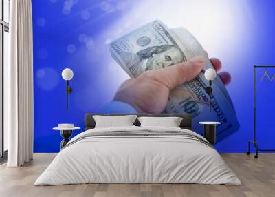 close up businessman hand holding pile of American hundred dollars over white background Wall mural