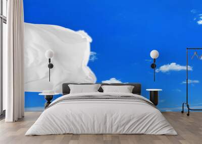 Conceptual image of waving blank white flag over sunny blue sky Wall mural