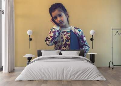 Cute modern little girl talks on phone. toned Wall mural