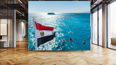 Egypt national flag waving on the wind of blue sky background. White yachts tourists in azure water Red sea, Arab Republic of Egypt. Tourists swim in the clear sea Wall mural