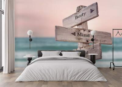 body mind soul text quote written on wooden signpost by the sea. positive pink turqoise pastel theme Wall mural