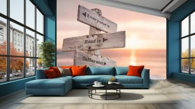 everyones road is different text quote written on wooden signpost at the beach during sunset. Wall mural