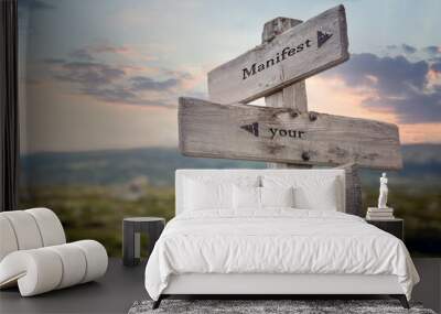 manifest your desires text quote on wooden signpost outdoors in nature. Wall mural