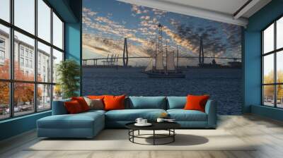 Tranquil sailboat in calm Charleston, SC harbor with beautiful sunset sky in background Wall mural