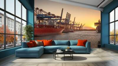 Container ships in the port of Hamburg at sunset  Wall mural