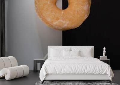 A donut and a cup of coffee are on a black and white background Wall mural