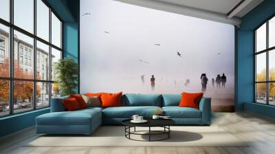 Standing in fog with birds in the sky Wall mural