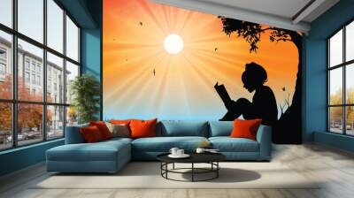 Young girl reading in sunset background Wall mural