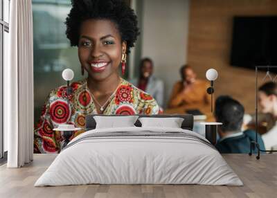 close up of beautiful young smiling professional black african business woman, coworkers hold a meeting in background Wall mural