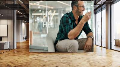 Mature businessman laughing over coffee during an office break Wall mural